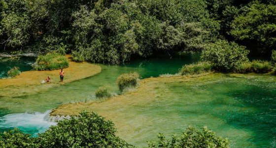 people swimming on Krka travertine system