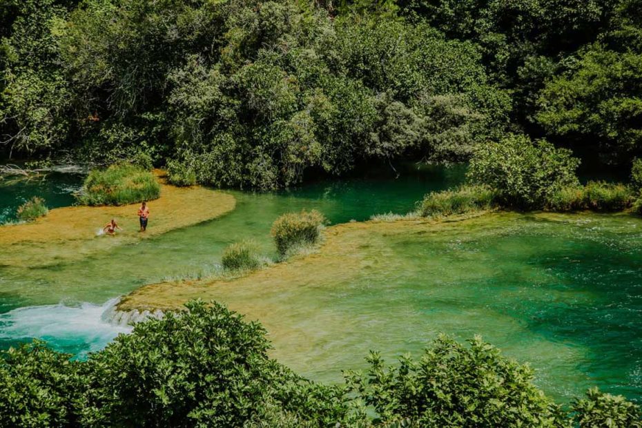 people swimming on Krka travertine system